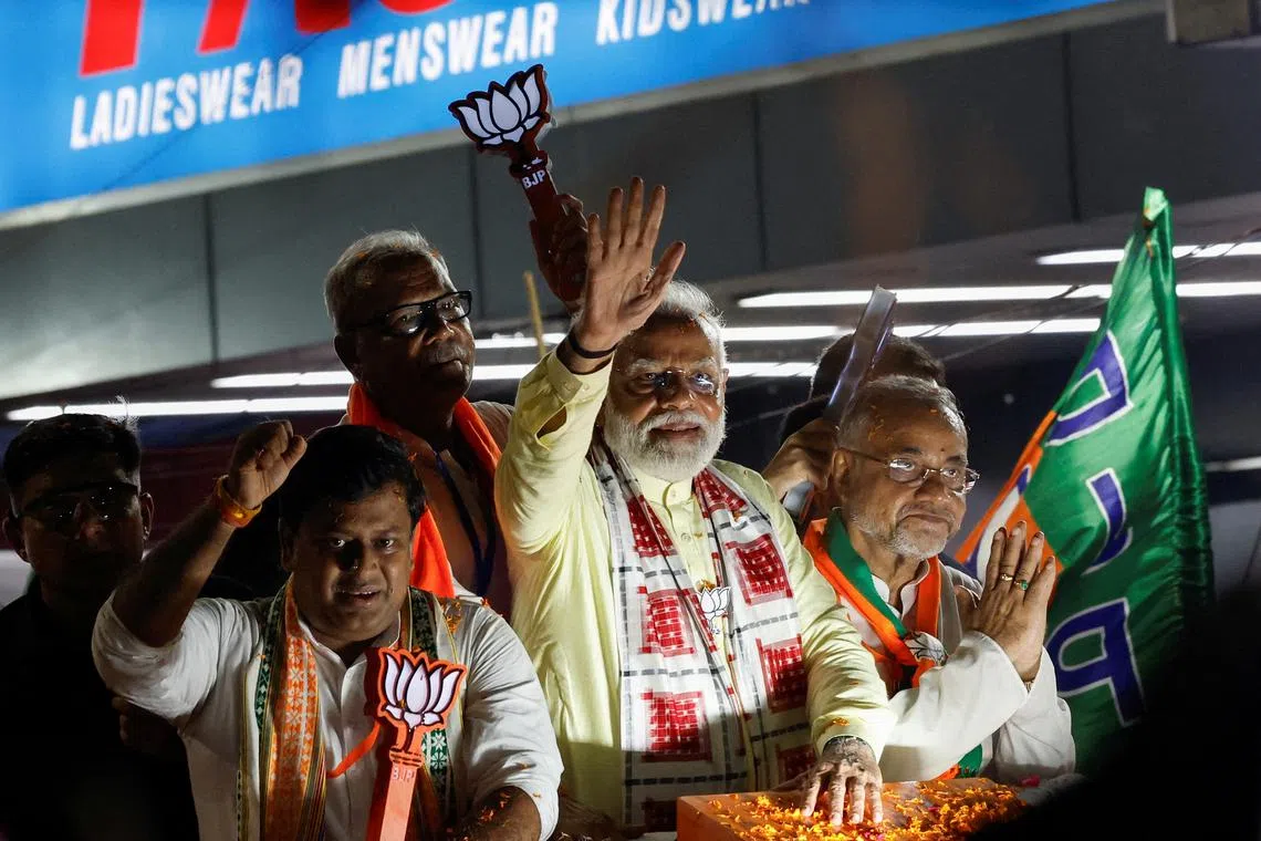 FILE PHOTO: India's Prime Minister Narendra Modi waves towards his supporters during a roadshow as part of an election campaign, in Kolkata, India, May 28, 2024. REUTERS/Sahiba Chawdhary/File Photo