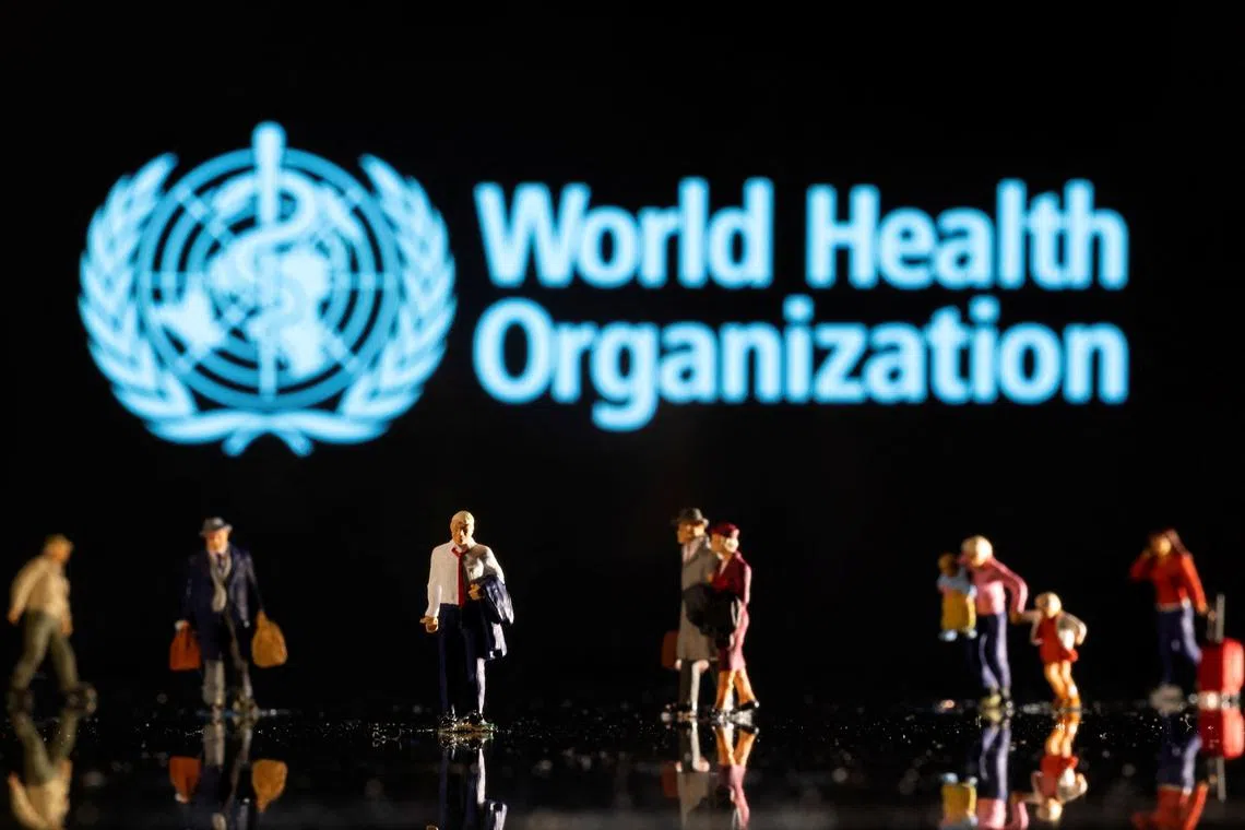 Small figurines are seen in front of displayed World Health Organization logo in this illustration taken February 11, 2022. REUTERS/Dado Ruvic/Ilustration/File Photo