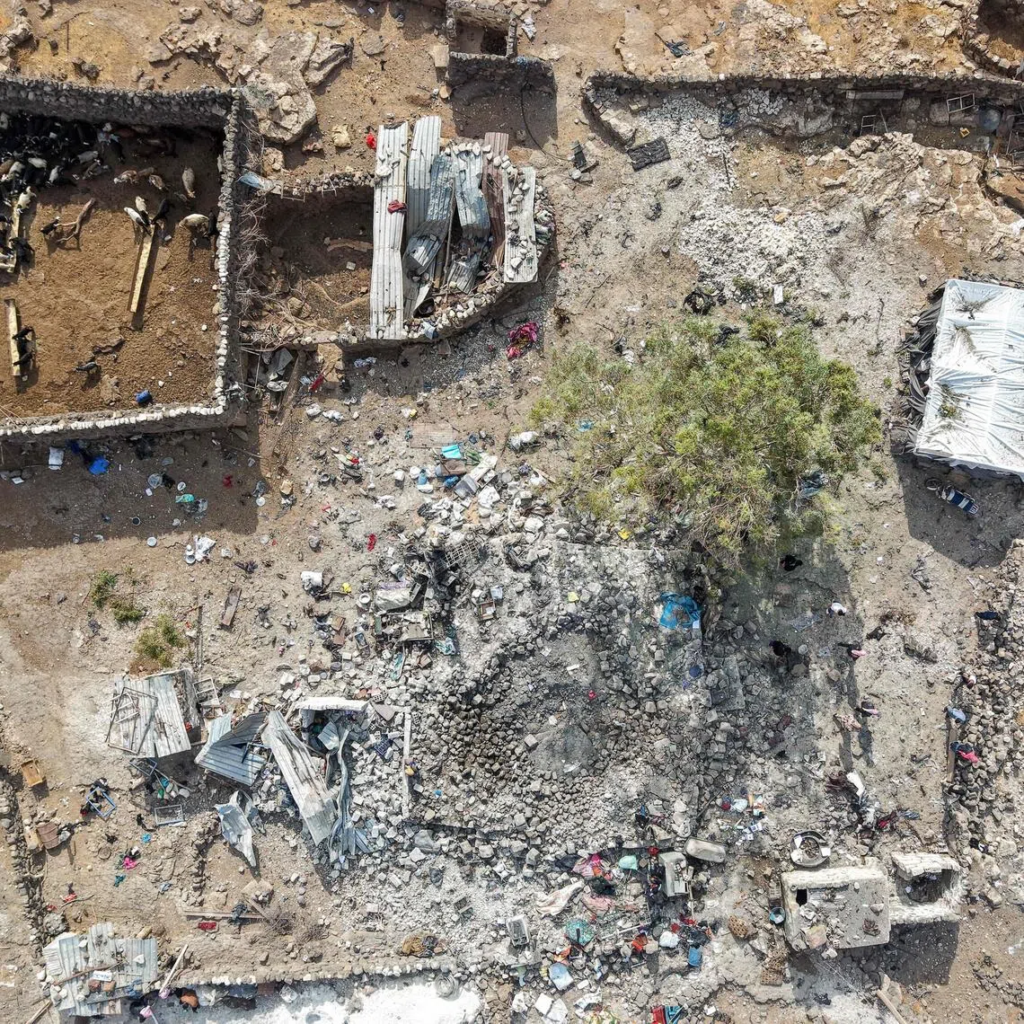 People inspecting the damage at a site targeted by Jordanian air strikes in the north-eastern countryside of Daraa on Oct 27.