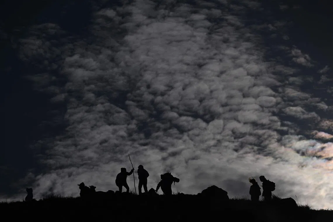 Tourists taking a morning excursion to the summit of the Izalco volcano in El Salvador, on July 27, 2025. 