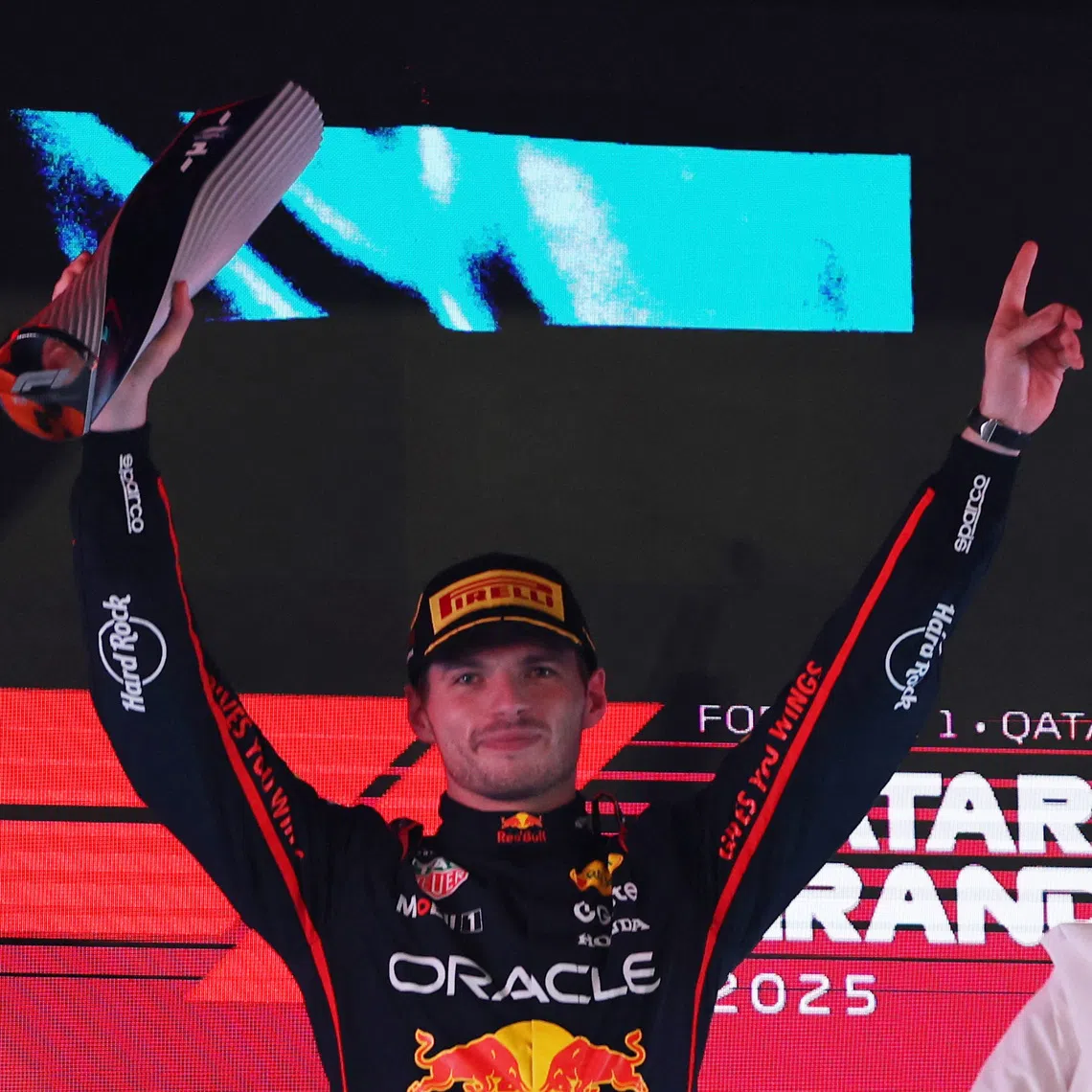 Formula One F1 - Qatar Grand Prix - Lusail International Circuit, Lusail, Qatar - November 30, 2025 Red Bull's Max Verstappen celebrates with a trophy on the podium after winning the Qatar Grand Prix REUTERS/Mohammed Salem
