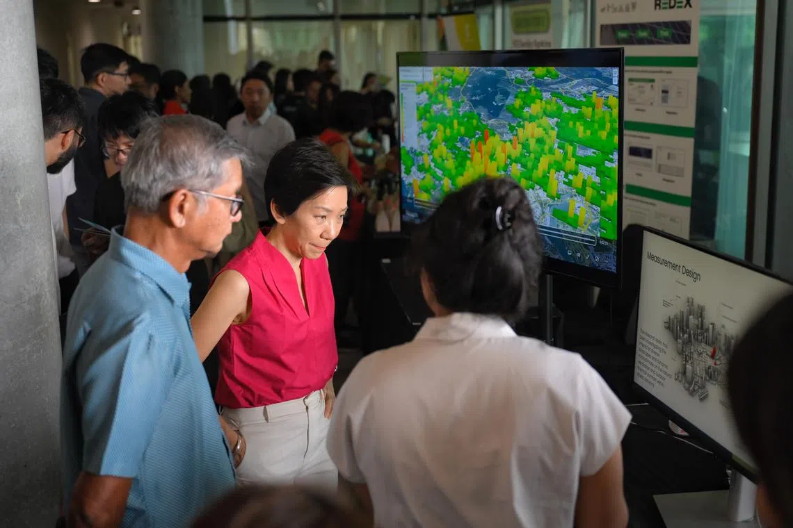 Minister for Sustainability and the Environment Grace Fu visits a booth after the launch of the partnership between NUS Cities and CapitaLand Development on Aug 26.