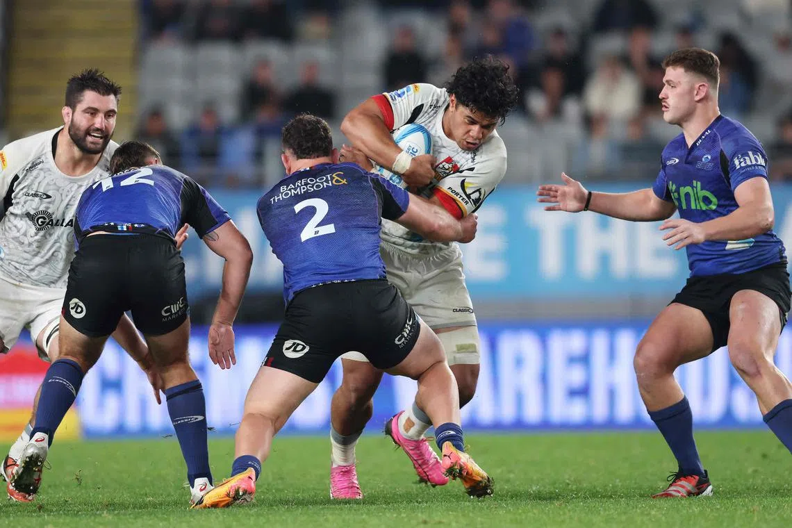 The Waikato Chiefs' Wallace Sititi is tackled by the Auckland Blues' Ricky Riccitelli in their Super Rugby match at Eden Park in Auckland on June 1, 2024.