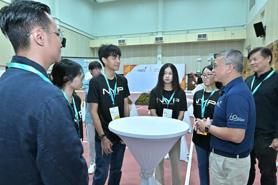 Minister for Culture, Community and Youth Edwin Tong interacts with Nanyang Polytechnic students at the NACLI's 60th anniversary event.