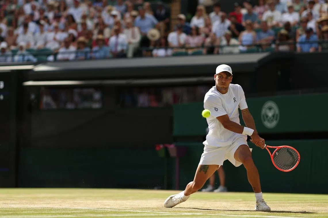 Flavio Cobolli hits a backhand against Alex de Minaur on day eight of Wimbledon.