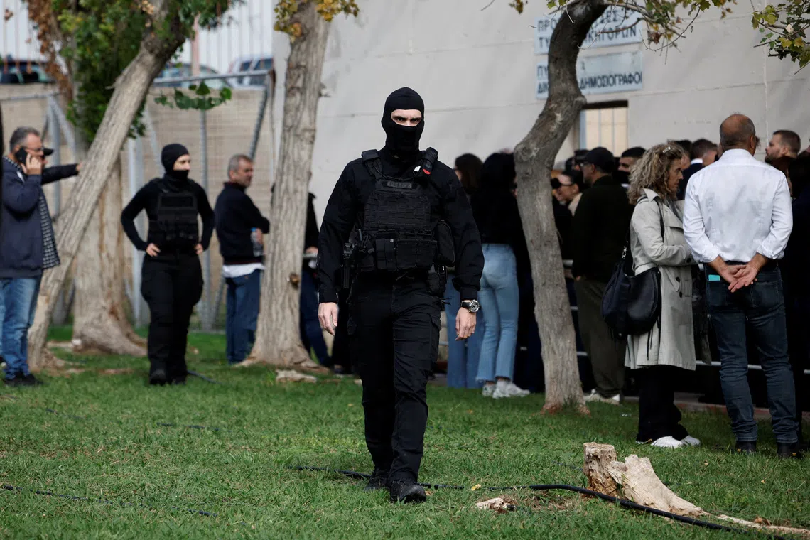 A police officer walks outside Athens' high security Korydallos prison before Olympiacos chairman Marinakis and fans' trial over deadly 2023 sports violence, in Athens, Greece, November 5, 2025. REUTERS/Louiza Vradi