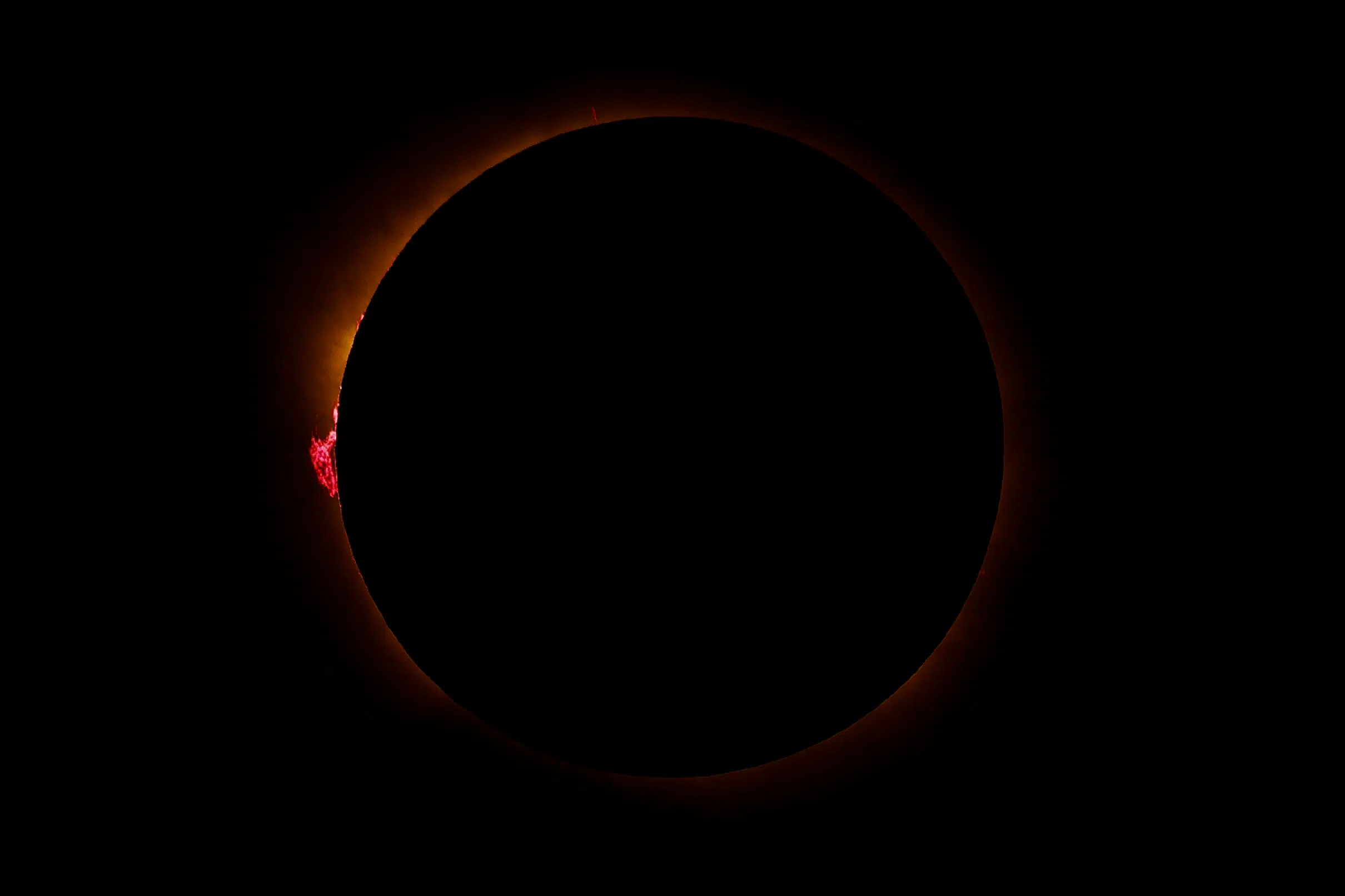 The Sun's corona glows as the Moon completely blocks the Sun during the totality phase of the total solar eclipse as seen from Berlanga de Duero, 240 km north-east of Madrid, on August 12, 2026. Millions of Europeans contemplated the sky in awe today during a rare total solar eclipse that will plunge a swathe of Spain into an eerie daytime darkness. The shadow cast when the Moon covers the Sun began in Russia's remote Arctic north at around 1700 GMT and continued in an arc through Greenland and Iceland. Spain is where most people viewed the total eclipse, which crossed the country diagonally from the northern Atlantic coast to the Mediterranean Sea, where it vanished at around 1830 GMT. (Photo by Oscar DEL POZO / AFP)
