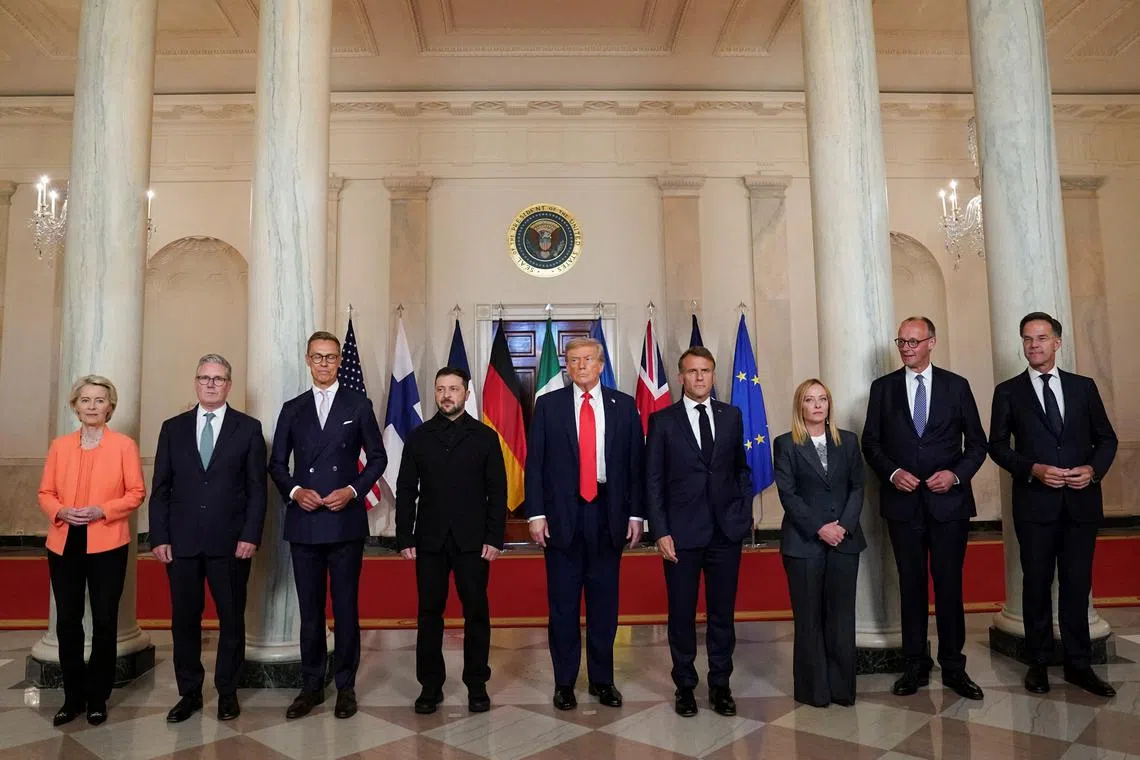 FILE PHOTO: U.S. President Donald Trump, Ukrainian President Volodymyr Zelenskiy, German Chancellor Friedrich Merz, French President Emmanuel Macron, British Prime Minister Keir Starmer, Italian Prime Minister Giorgia Meloni, NATO Secretary General Mark Rutte, European Commission President Ursula von der Leyen, and Finland's President Alexander Stubb, pose for a family photo amid negotiations to end the Russian war in Ukraine, at the White House in Washington, D.C., U.S., August 18, 2025. REUTERS/Alexander Drago/File Photo