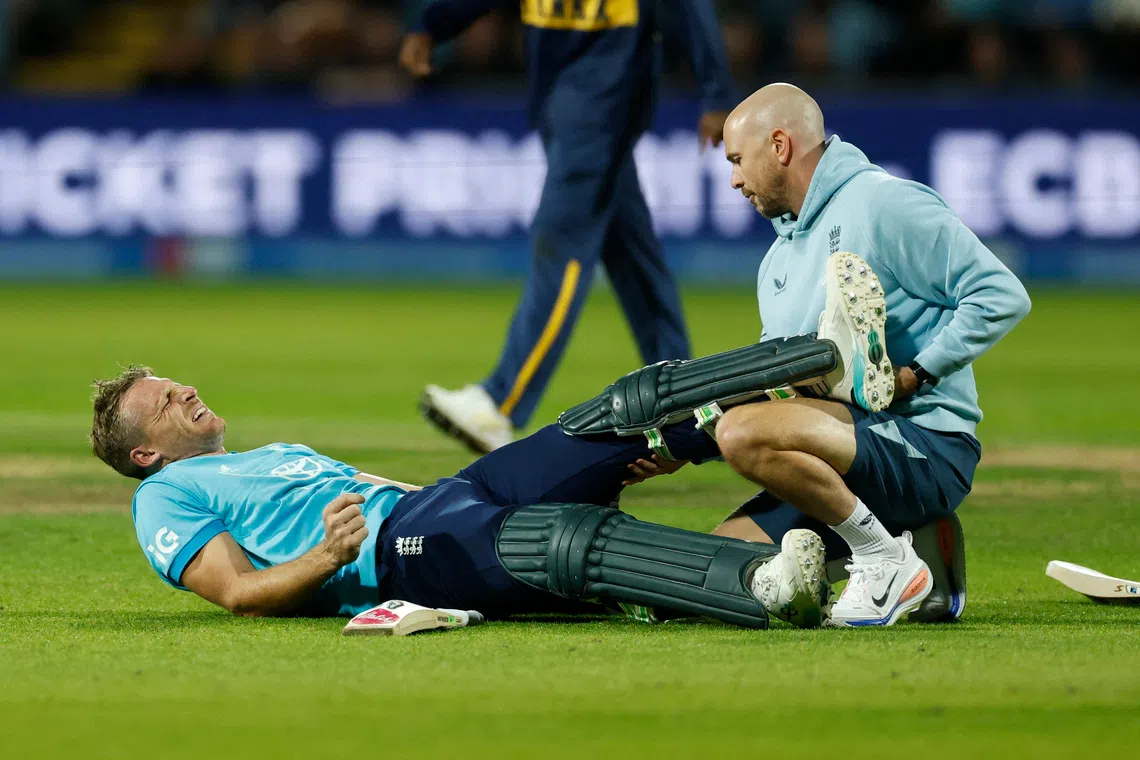 Cricket - Second One Day International - England v Sri Lanka - Headingley Cricket Ground, Leeds, Britain - September 24, 2026 England's Jos Buttler receives medical attention after sustaining an injury Action Images via Reuters/Jason Cairnduff