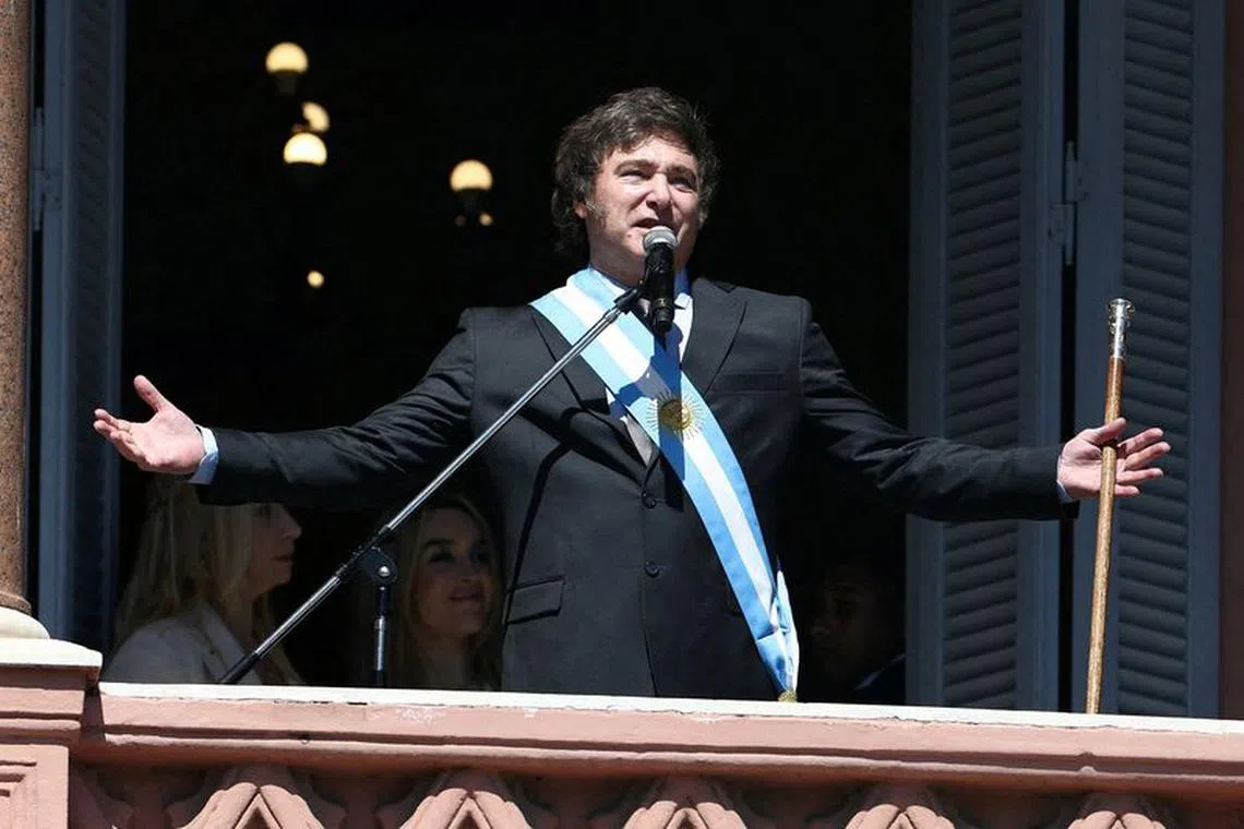 FILE PHOTO: Argentina's President Javier Milei addresses supporters from the Casa Rosada balcony, as his sister Karina Milei and his partner Fatima Florez look on, after his swearing-in ceremony, in Buenos Aires, Argentina December 10, 2023. REUTERS/Agustin Marcarian/File Photo