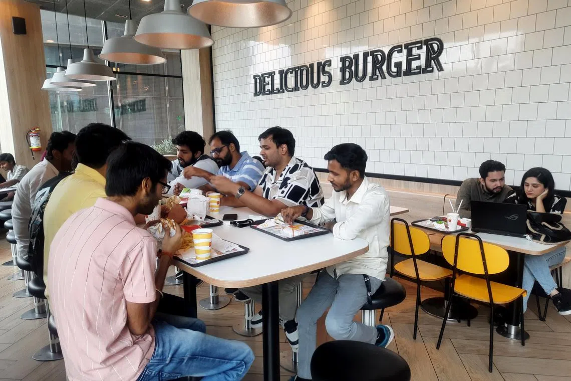 A group of Indians eating lunch at a McDonald's outlet in Noida on May 16. Indians have been advised to cut down on their consumption of food high in salt, sugar and fat, according to recent government guidelines. 
