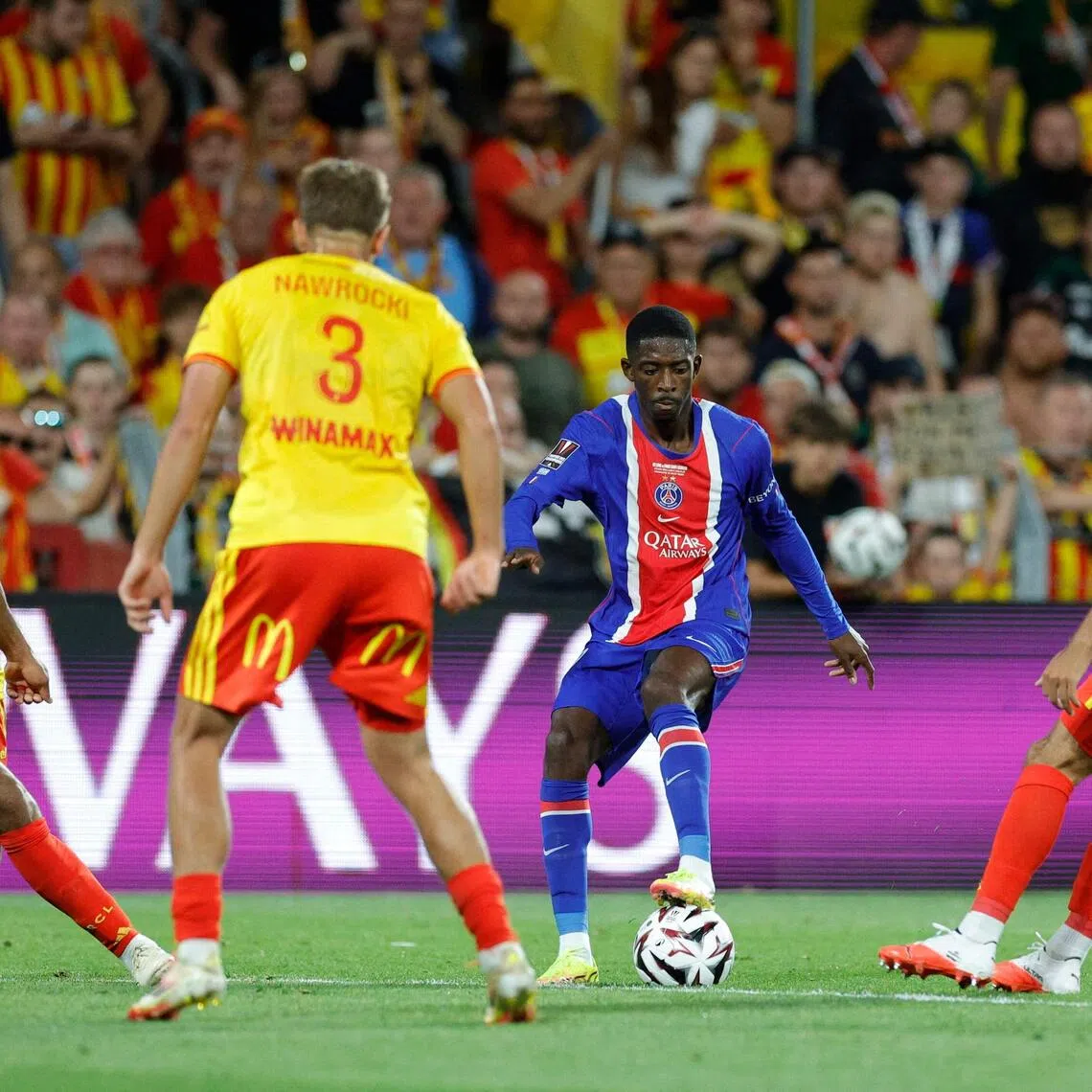 PSG’s reigning Ballon D’or winner Ousmane Dembele surrounded by three Lens players.