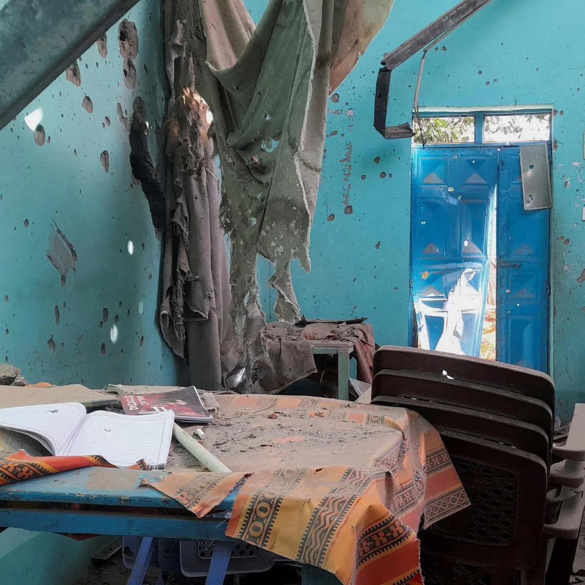 A desk bearing signs of shelling in a school where displaced people are sheltering, in El Fasher, Sudan, October 7, 2025. REUTERS/Mohyaldeen M Abdallah