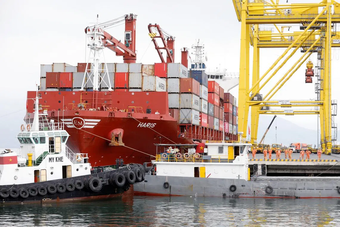 FILE PHOTO: Containers are loaded onto a ship at Tien Sa port in Da Nang city, Vietnam, March 6, 2020. REUTERS/Kham/File Photo