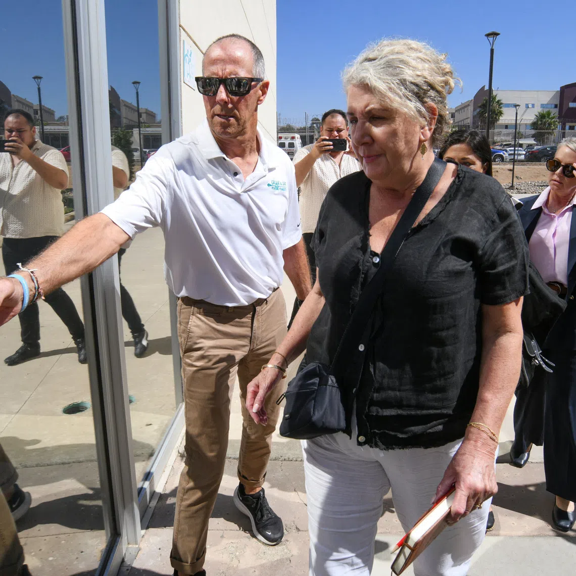 Martin and Debra Robinson, parents of Australian brothers Callum and Jake Robinson, who were killed during a surfing trip in April 2024, arrive at the Baja California State Palace of Justice for closing arguments in the trial of three men accused of murdering the brothers and their US friend Carter Rhoad, in Ensenada, Mexico, October 8, 2026. REUTERS/Enrique Botello