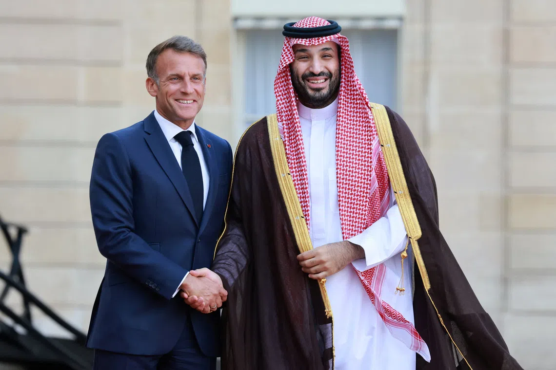 French President Emmanuel Macron (left) with Saudi Crown Prince Mohammed bin Salman as he arrives for a meeting at the Elysee Palace in Paris on Aug 24.