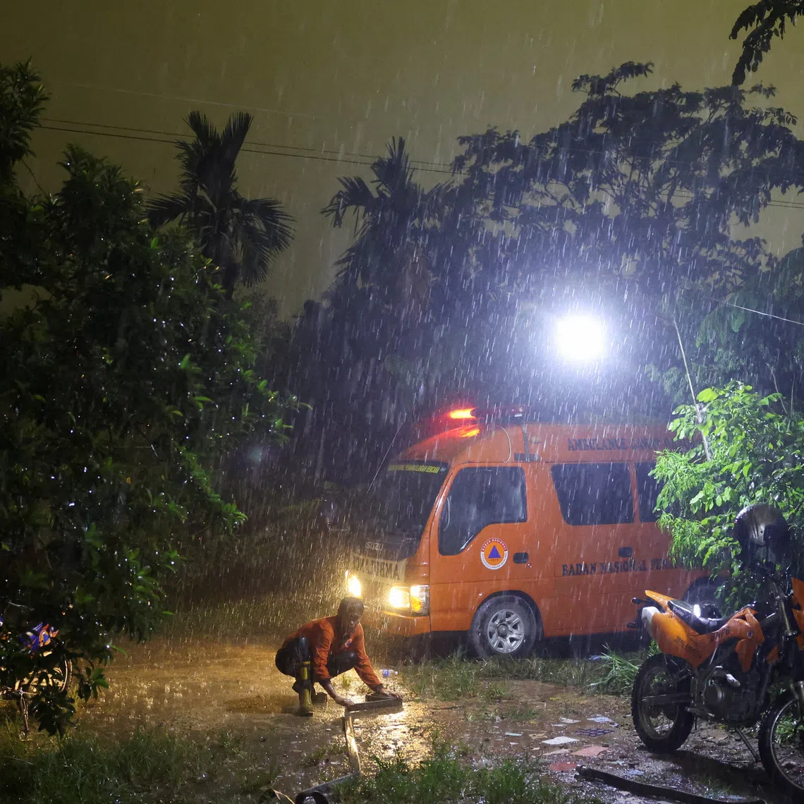 A staff member of the Regional Disaster Agency (BPBD) rolls a hose after extinguishing a fire in a peatland area burnt by wildfires, during heavy rains, in Kubu Raya, West Kalimantan province, Indonesia, September 15, 2026. REUTERS/Ajeng Dinar Ulfiana TPX IMAGES OF THE DAY