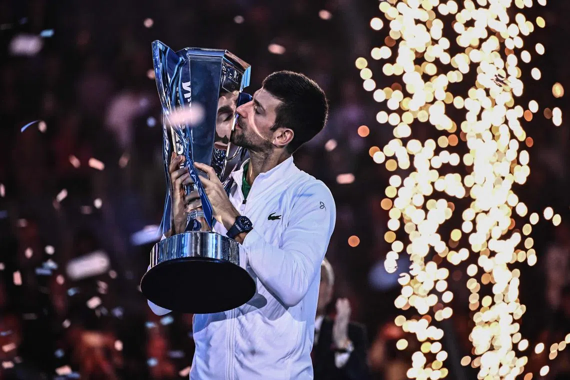 Novak Djokovic kisses the winner's trophy after winning the men's single final match against Casper Ruud.