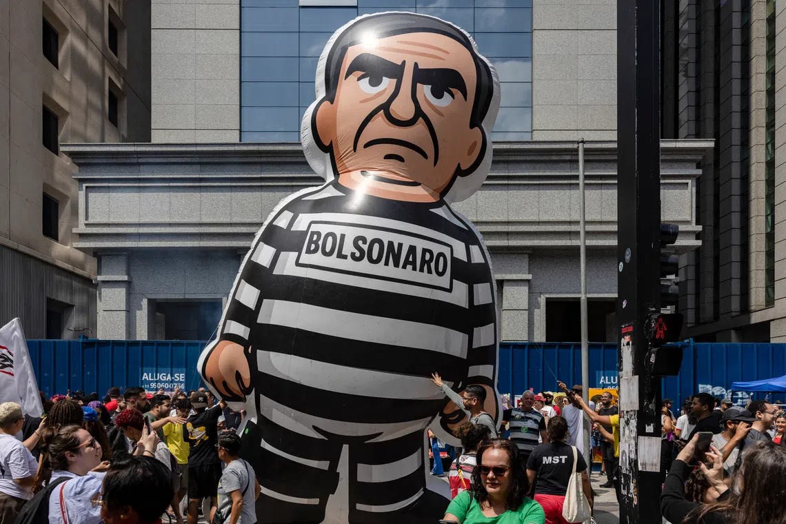 Brazilians celebrating the arrest of former president Jair Bolsonaro in Sao Paulo on Nov 23, after he was accused of taking a soldering iron to his ankle monitor.