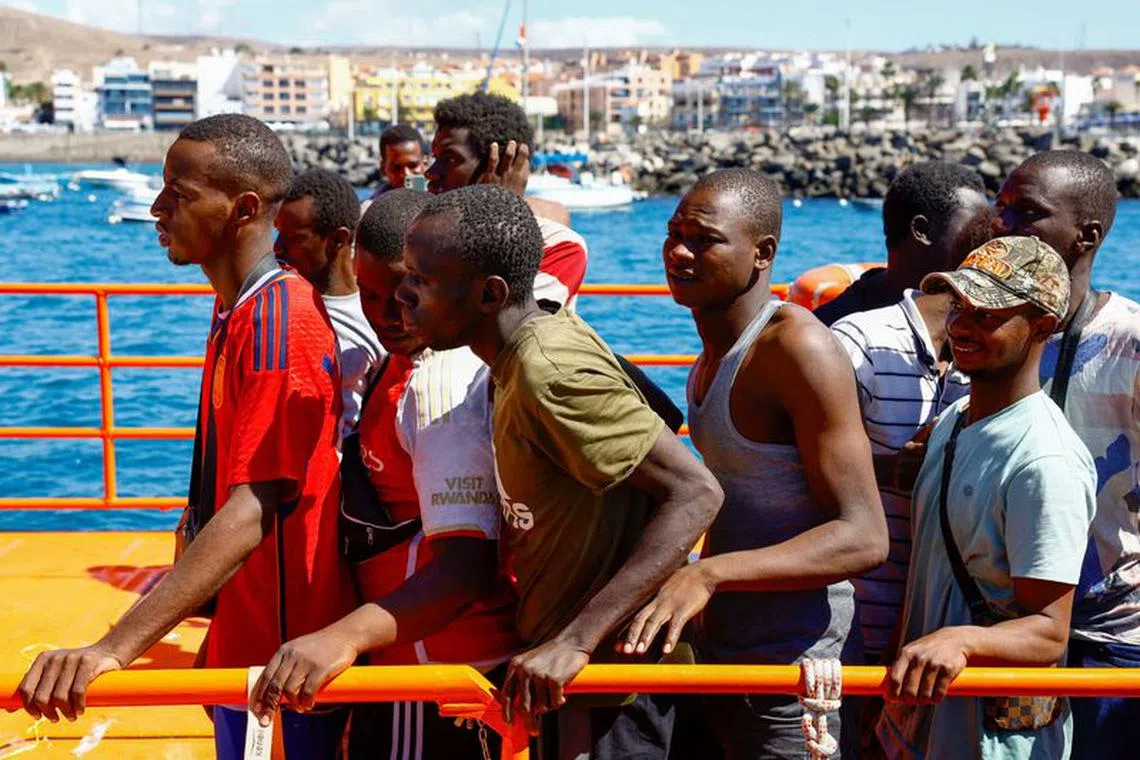 Migrants wait to disembark from a Spanish coast guard vessel, in the port of Arguineguin, on the island of Gran Canaria, Spain, October 19, 2023. REUTERS/Borja Suarez