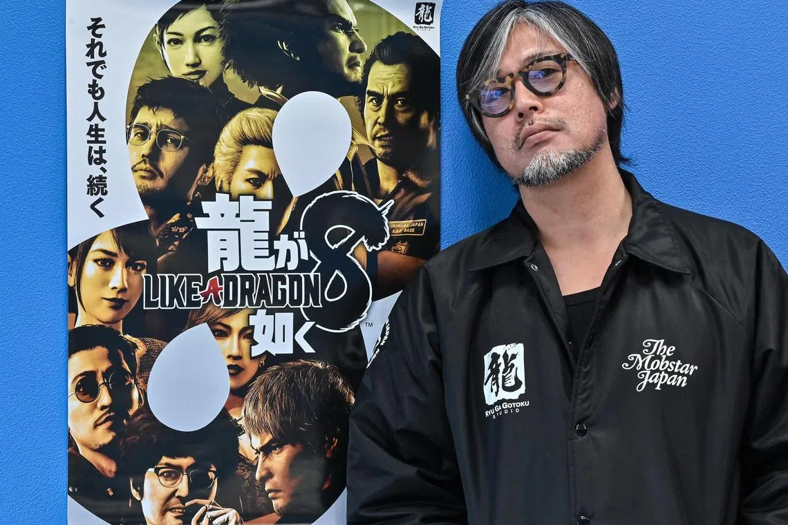Executive officer, producer and director Masayoshi Yokoyama posing next to a promotional poster at the headquarters of game and entertainment giant Sega in Tokyo on Jan 10, 2024.