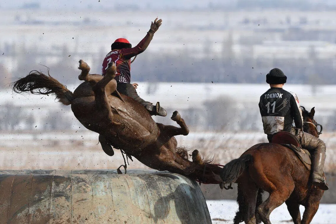 Kyrgyz horse riders playing the traditional Central Asian sport of "Kok-Boru" (Gray Wolf) or "Buzkashi" (Goat Grabbing) in the settlement of Don-Aryk, some 80km from Bishkek, Kyrgyzstan on Jan 27, 2026. Mounted players compete for points by throwing a stuffed sheepskin into a well. 