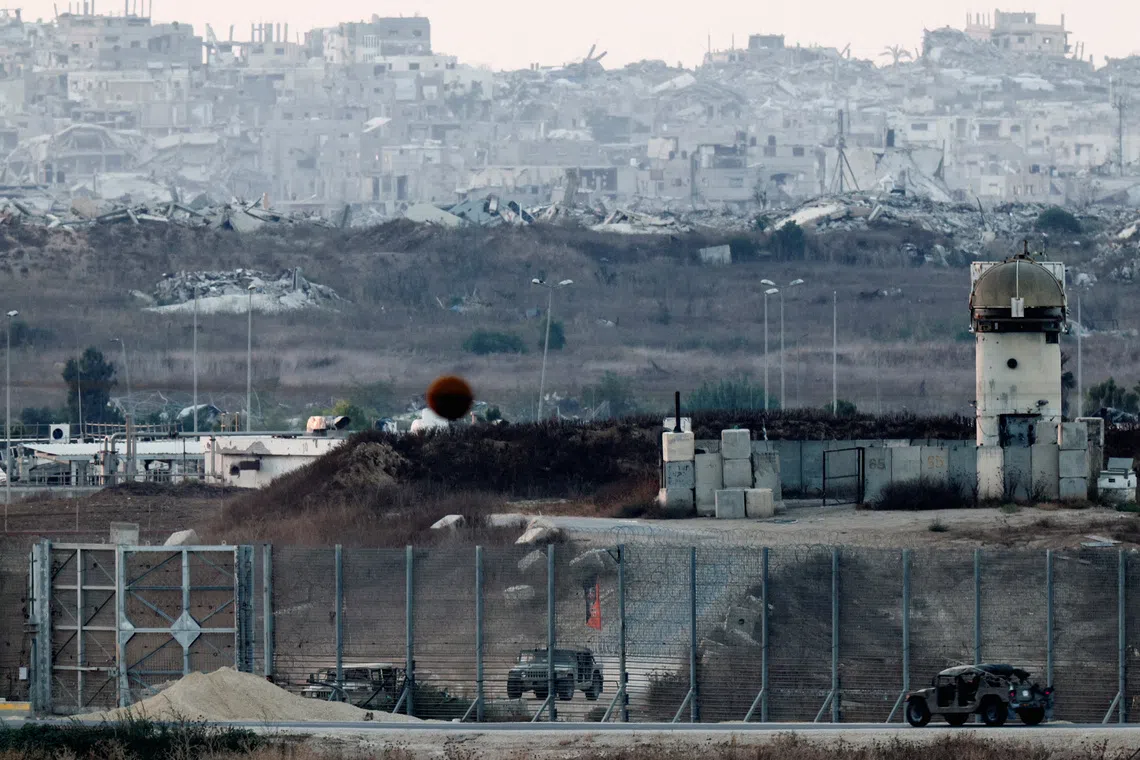 Military vehicles on the border with Gaza, as seen from the Israeli side of the border, on Aug 2.