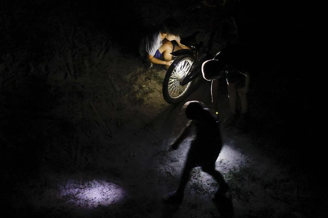 epa11566024 Children play in the dark with the aid of flashlights in a residential area during an electricity blackout in Kyiv, Ukraine, 26 August 2024, after Russian shelling of all Ukraine territory. The main targets of shelling were electricity objects, Ukrainian President Volodymyr Zelensky wrote on his Telegram channel that Ukraine experienced 127 missiles and 109 drones attack. The attack targeted critical civilian infrastructure across the country, resulting in casualties and injuries. The Ukrainian president expressed his condolences to the victims' families and assured that injured people are receiving necessary assistance. Russian troops entered Ukrainian territory on 24 February 2022, starting a conflict that has provoked destruction and a humanitarian crisis. EPA-EFE/SERGEY DOLZHENKO