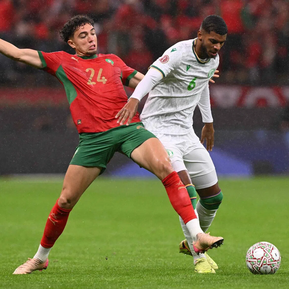 Morocco midfielder Neil El Aynaoui (left) fighting for the ball with Comoros midfielder Iyad Mohamed during Morocco's 2-1 win in their Africa Cup of Nations Group A football match at Prince Moulay Abdellah Stadium in Rabat on Dec 21, 2025.