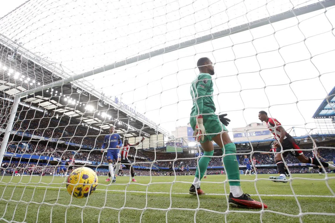 Soccer Football - Premier League - Chelsea v Brentford - Stamford Bridge, London, Britain - October 28, 2023 Brentford's Ethan Pinnock celebrates scoring their first goal as Chelsea's Robert Sanchez reacts Action Images via Reuters/Matthew Childs/ File Photo