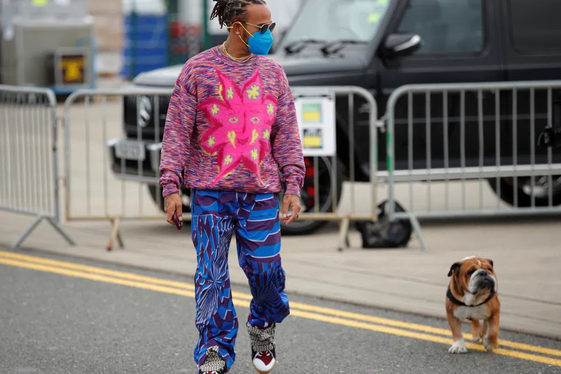FILE PHOTO: Formula One F1 - British Grand Prix - Silverstone Circuit, Silverstone, Britain - July 15, 2021 Mercedes' Lewis Hamilton arrives with his dog Roscoe ahead of the British Grand Prix REUTERS/Andrew Couldridge/File Photo