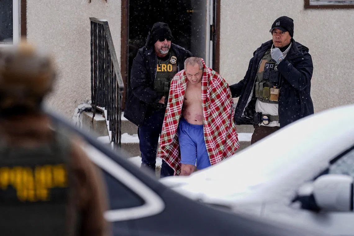 A man, whose family requested a Hmong interpreter, is detained after ICE agents and other law enforcement officers conducted an immigration raid at his home, days after an ICE agent fatally shot Renee Nicole Good, in St. Paul, Minnesota, U.S., January 18, 2026. REUTERS/Leah Millis