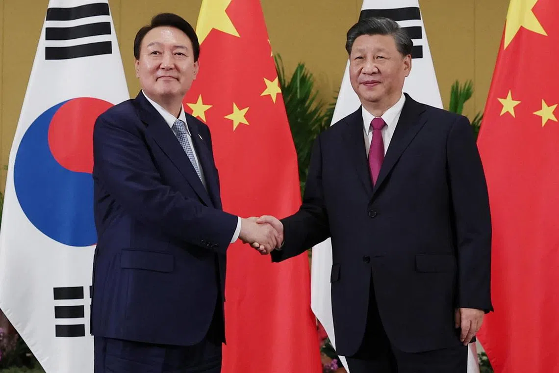 Chinese President Xi (right) told South Korean President Yoon Suk-yeol that the two countries’ relationship is important.