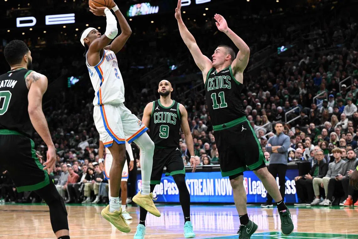 Shai Gilgeous-Alexander of the Oklahoma City Thunder attempts a basket against Payton Pritchard of the Boston Celtics during the fourth quarter at the TD Garden.