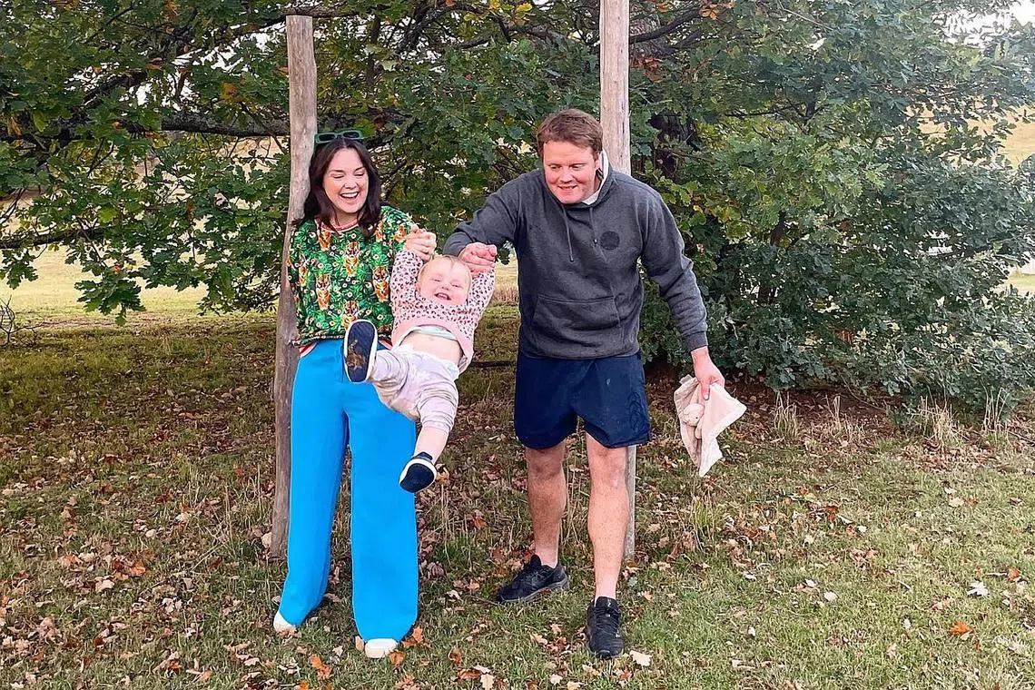 Ms Emma Baker, her husband James Wilson and their 20-month-old daughter in their new hometown of Mudgee. 