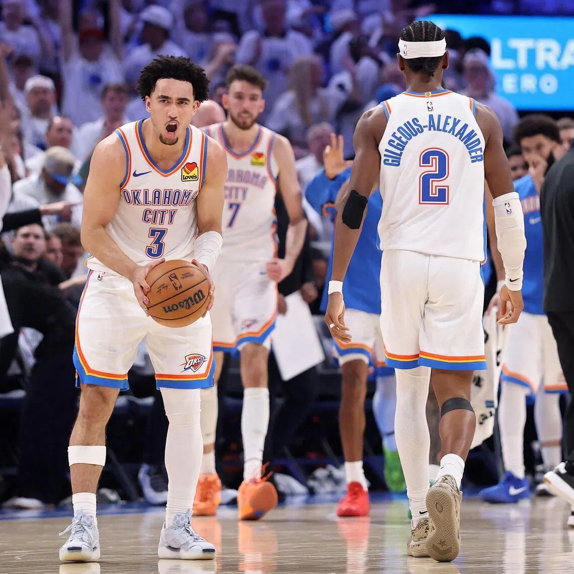 Jared McCain (left) and Shai Gilgeous-Alexander of the Oklahoma City Thunder celebrating during the fourth quarter of their 127-114 Game 5 win over the San Antonio Spurs in the NBA Western Conference finals at Paycom Center on May 26, 2026 in Oklahoma City.
