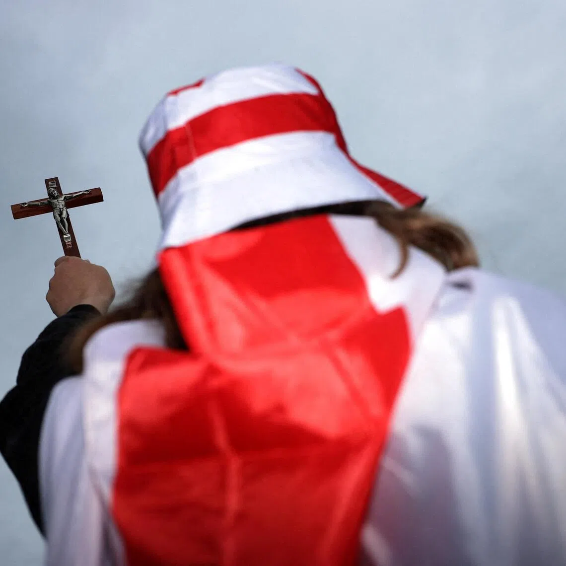 A protester holding a crucifix takes part in a “Unite the Kingdom” rally organised by far-right, anti-Muslim campaigner Stephen Yaxley-Lennon - also known as Tommy Robinson - in London, in May 2026.