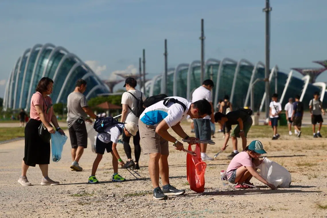 People taking part in SG Clean Day in the Marina Bay area in 2023. Overall, as a society, Singaporeans have become people used to paying others to clean up their mess.