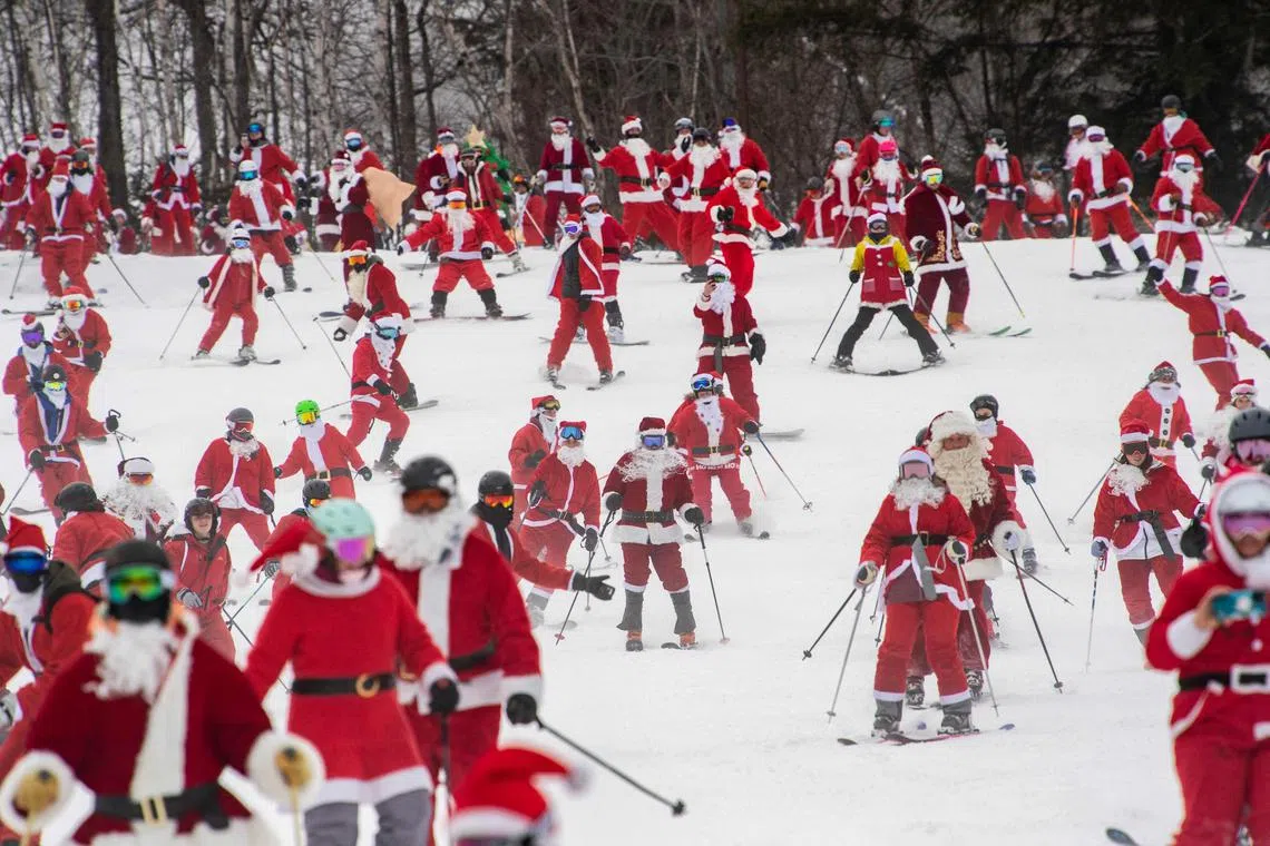 More than three hundred skiers and snowboarders dressed as Santa Claus, and other holiday characters, take off from the top of the mountain as they take part in the “Santa Sunday” event at Sunday River Resort in Newry, Maine, U.S., on Dec 11, 2022. Money raised by the the event goes towards the River Fund Maine charity. 