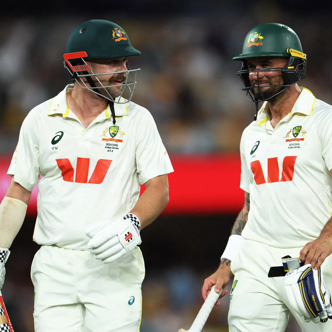 Cricket - The Ashes - Australia v England - Second Test - The Gabba, Brisbane, Australia - December 7, 2025 Australia's Travis Head and Jake Weatherald walk off for dinner break REUTERS/Hollie Adams