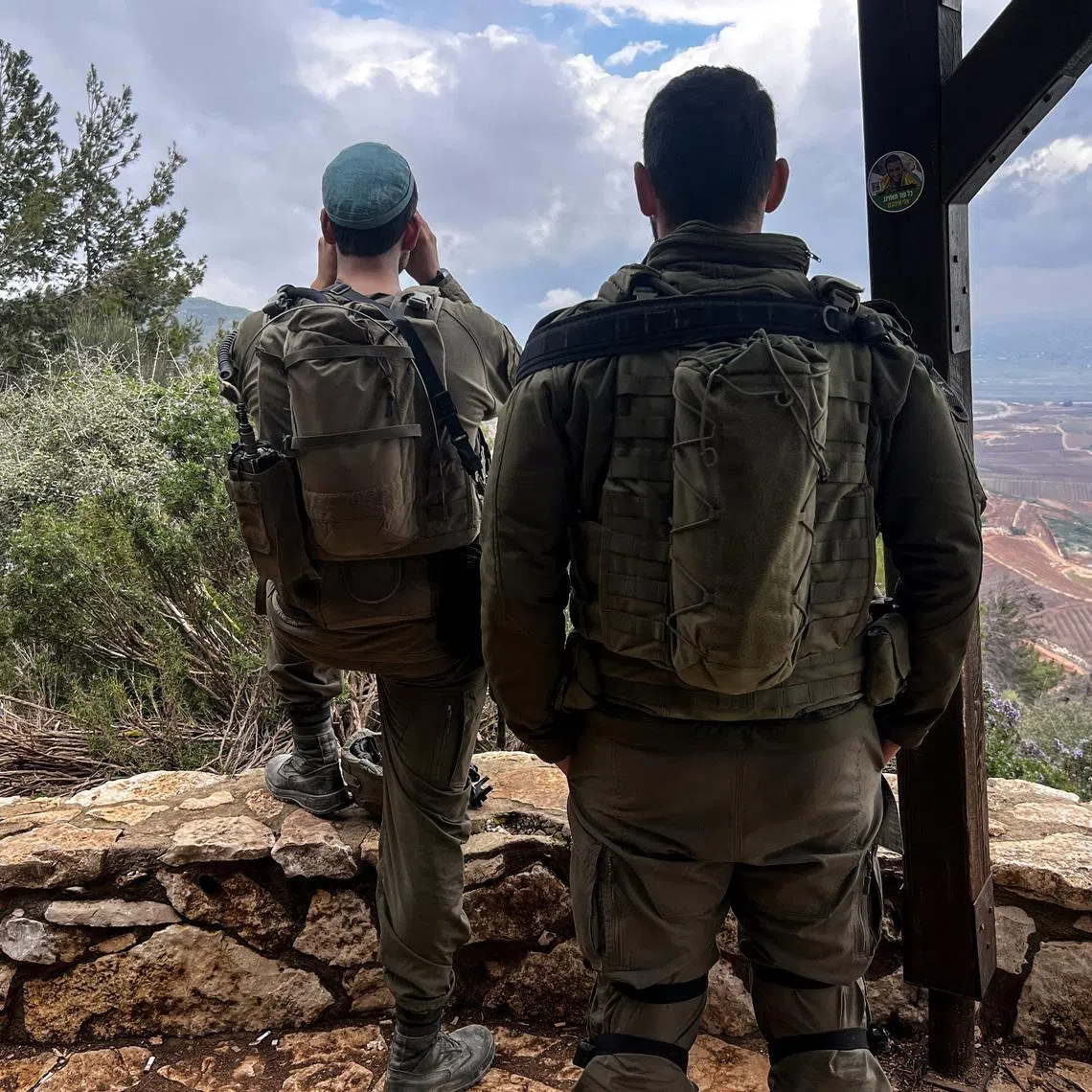 Israeli soldiers look towards Lebanon, amid an escalation between Iran-backed Hezbollah and Israel, and amid the U.S.-Israeli conflict with Iran, by the Israel-Lebanon border in northern Israel March 7, 2026. REUTERS/Avi Ohayon