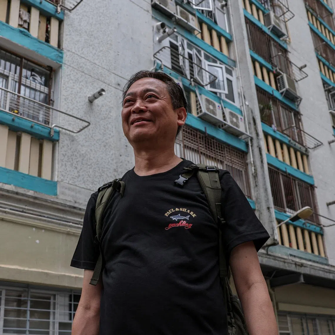 Jason Kong, 65 years-old, walks towards a building at Wang Fuk Court to retrieve personal belongings during his first return visit after a deadly fire last year, in Hong Kong, China, April 23, 2026. REUTERS/Tyrone Siu