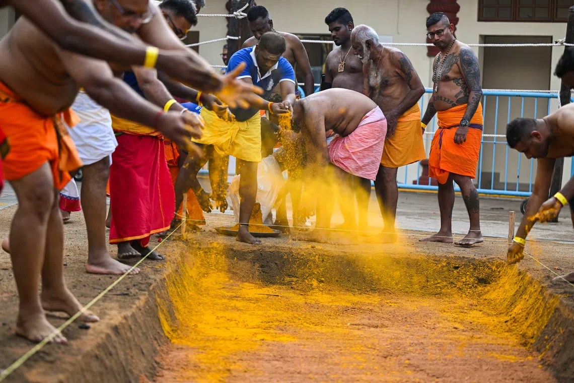 Devotees scatter turmeric into the pit before laying the firewood. Turmeric is regarded as auspicious in Hinduism. 