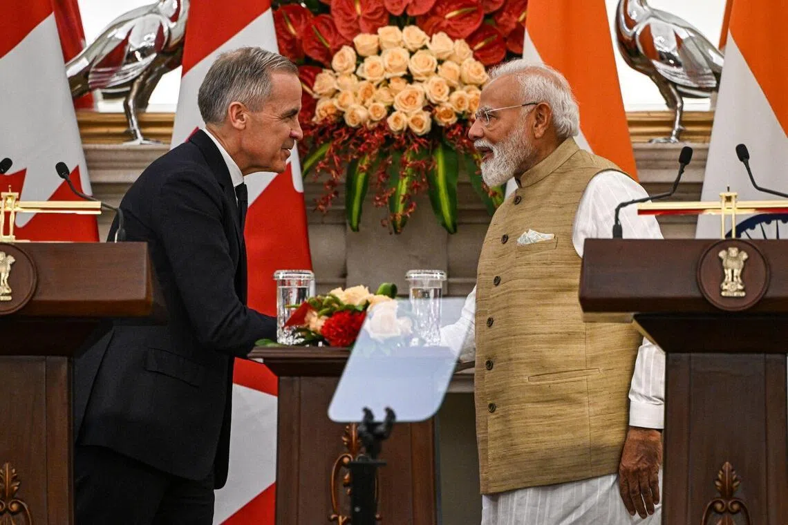 Narendra Modi, India's prime minister, right, shakes hands with Mark Carney, Canada's prime minister, during a news conference at Hyderabad House in New Delhi, India, on Monday, March 2, 2026. Carney met Modi in New Delhi on Monday to reset relations after years of strain, with both leaders looking to clinch deals to boost trade and supply chains. Photographer: Prakash Singh/Bloomberg