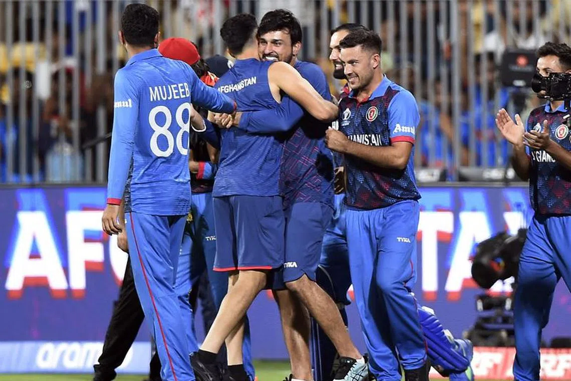 Cricket - ICC Cricket World Cup 2023 - Pakistan v Afghanistan - MA Chidambaram Stadium, Chennai, India - October 23, 2023 Afghanistan players celebrate after winning the match by 8 wickets REUTERS/Samuel Rajkumar