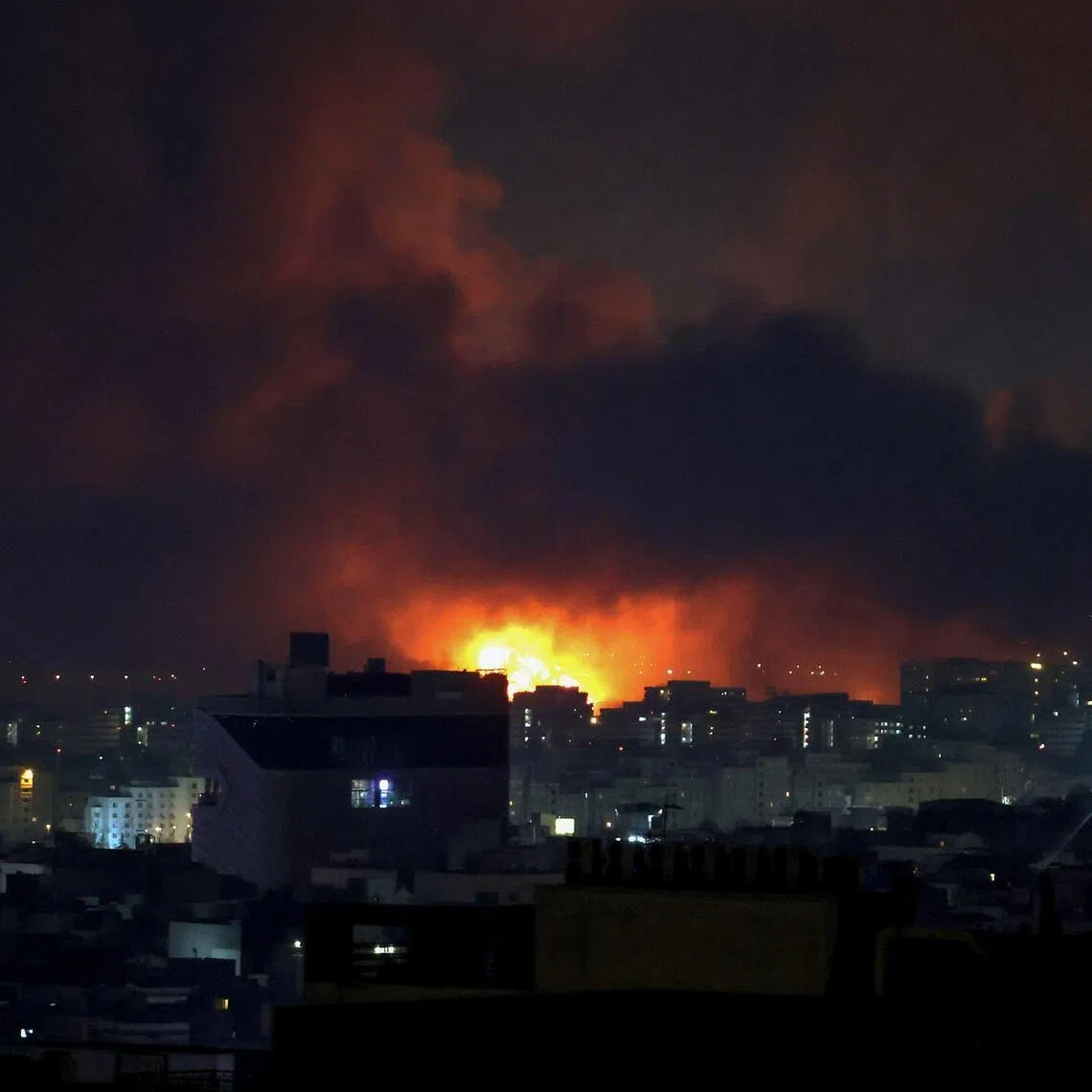 Smoke and fire rise from the site of air strikes at Mehrabad International Airport in Tehran on March 7, 2026.
