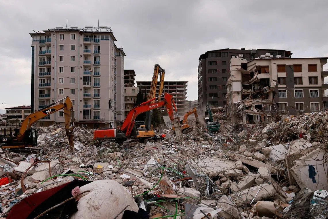 Workers clearing the rubble of a collapsed building in Antakya, Turkey, on Feb 21, 2023.