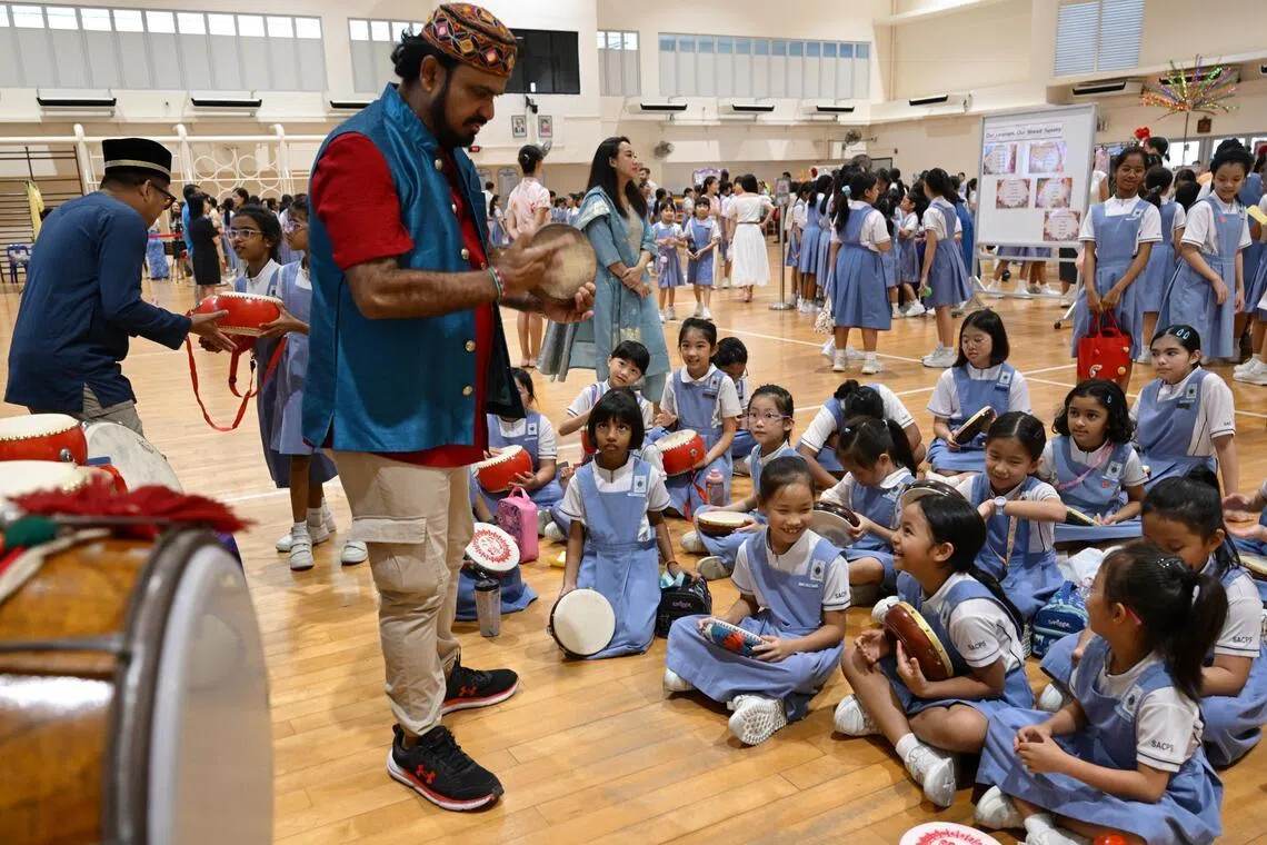 Students from St Anthony’s Canossian Primary School play traditional Malay hand held drums, or kompang, as part of their Racial Harmony Day celebrations on July 21.