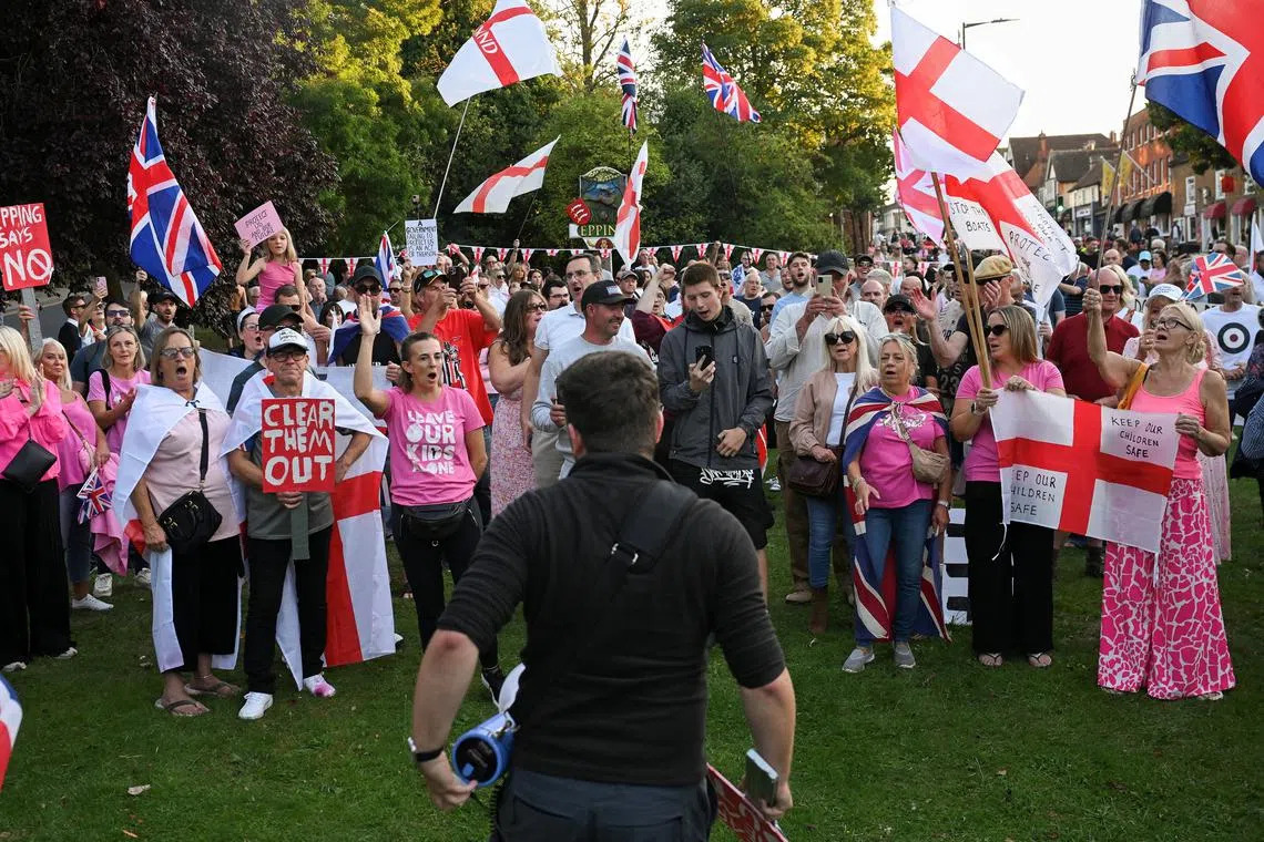 FILE PHOTO: Protesters attend an anti-immigration demonstration, in Epping, Britain, August 8, 2025. REUTERS/Jaimi Joy/File Photo