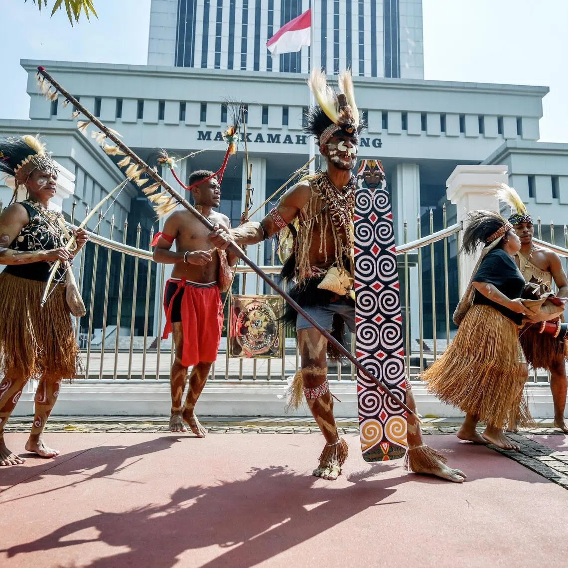 Representatives of the Awyu and Moi indigenous tribes dance and perform rituals in front of the Supreme Court building during a protest in Jakarta on May 27, 2024.